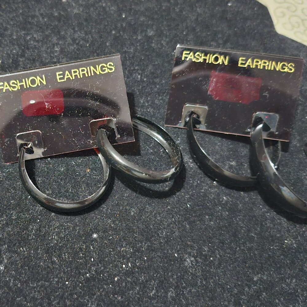 Lot of three black hoop earrings